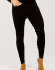 Person wearing black leggings on a white background