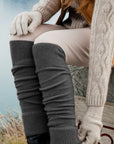 Woman wearing grey legwarmer outside.