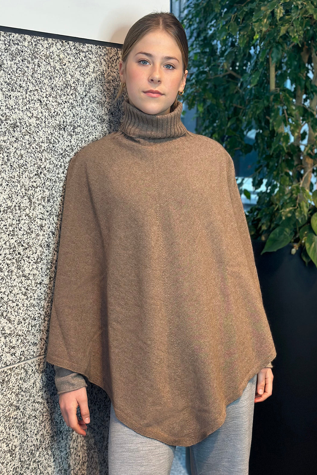 Woman wearing a brown poncho wrap