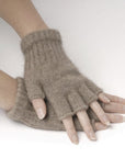Brown fingerless gloves worn on a white background