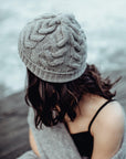 Woman wearing a light grey beanie outside