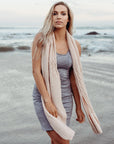Woman wearing a pink Alpaca Patch Scarf on beach