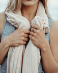 Woman wearing a pink Alpaca Patch Scarf