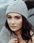 Woman wearing a light grey beanie outside