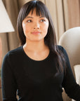 Women wearing a black merino thermal base layer top