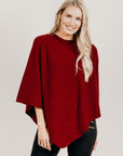 Woman wearing a fire poncho with black pants