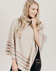 Woman wearing a Lichen Merinosilk Stripe Poncho with black pants