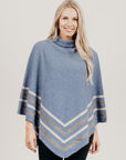 Woman wearing a ice Merinosilk Stripe Poncho with black pants