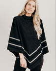 Woman wearing a charcoal Merinosilk Stripe Poncho with black pants