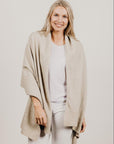 Woman wearing a lichen Merinosilk Ribbed Wrap with white pants
