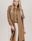 Woman wearing a light brown Classic Cervelt Scarf - Kapeka NZ, Made from New Zealand Red Deer Fibre. Very Soft and rare Fibre. Only made in New ZealandClassic Cervelt Wrap - Kapeka NZ