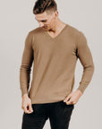 Man wearing a light brown v Classic Cervelt sweater and black pants - Kapeka NZ, Made from New Zealand Red Deer Fibre. Very Soft and rare Fibre. Only made in New ZealandCervelt Luxury V Neck -