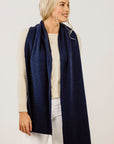 Woman wearing a navy blue scarf on a white background