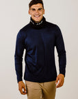 A man wearing a black Merinosilk neck warmer with grey stripes, smiling against a white background.