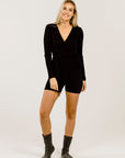 Woman wearing black outfit and a pair of charoal socks
