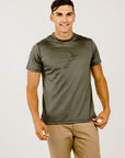 A male model wearing a short-sleeved green Merino wool t-shirt with a crew neckline, standing against a plain background.