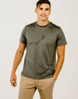 Man wearing a green t-shirt with a logo on a white background