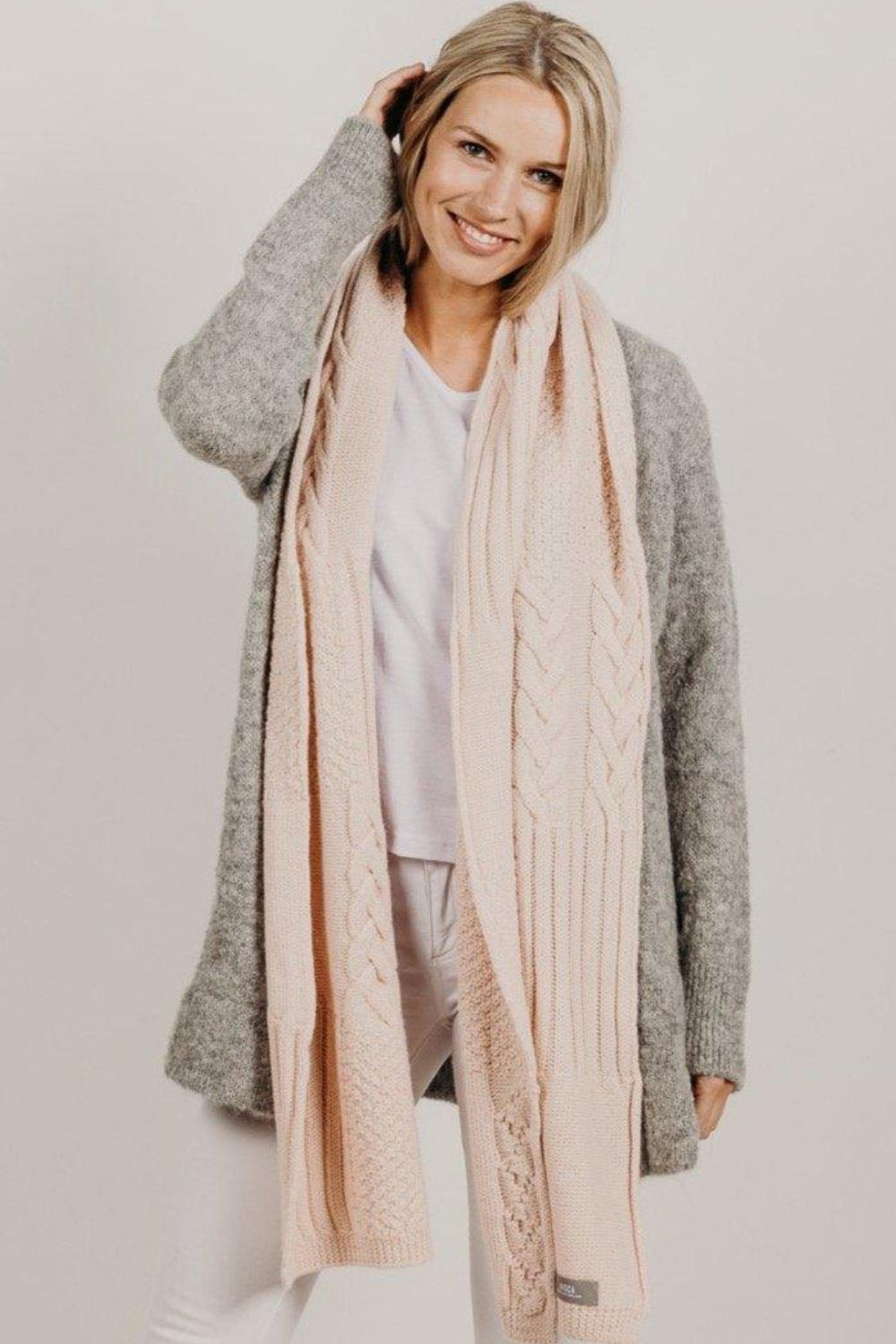 Woman wearing a pink Alpaca Patch Scarf 